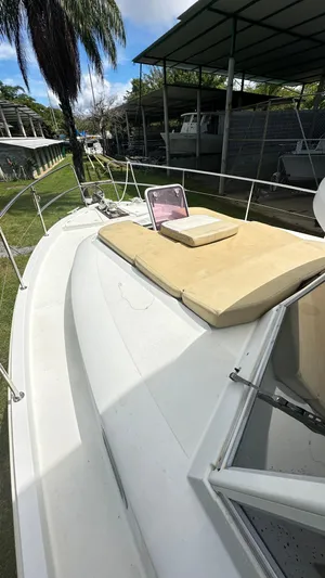  Yacht Photos Pics 2009 Beneteau Swift Trawler 34 deck with sun pad and hatch, docked under cover.