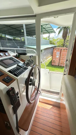  Yacht Photos Pics Interior view of 2009 Beneteau Swift Trawler 34 helm with wooden flooring.