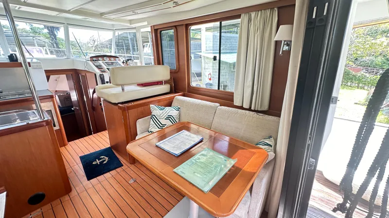  Yacht Photos Pics Interior of 2009 Beneteau Swift Trawler 34, featuring cozy seating and wooden finishes.
