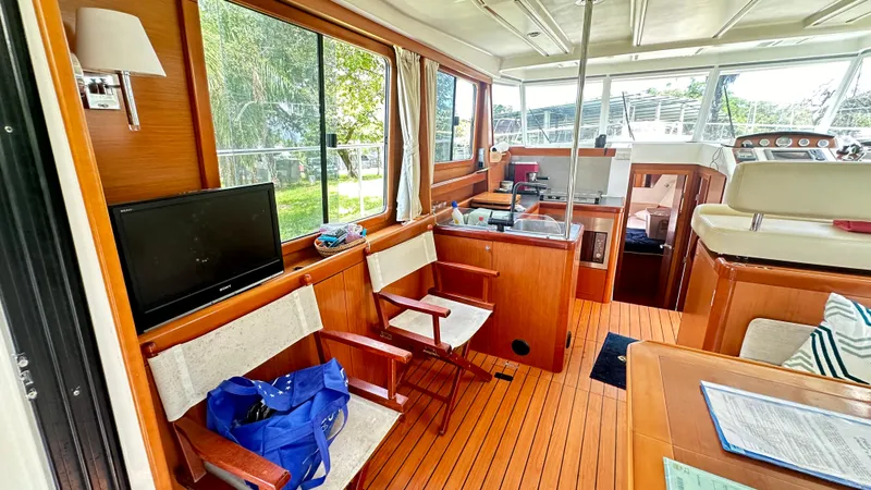  Yacht Photos Pics Interior of 2009 Beneteau Swift Trawler 34 with wooden flooring and seating area.