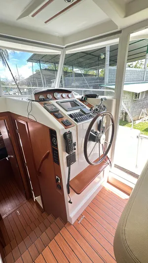  Yacht Photos Pics 2009 Beneteau Swift Trawler 34 helm station with wooden flooring and modern controls.