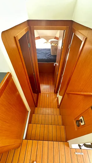  Yacht Photos Pics Interior view of 2009 Beneteau Swift Trawler 34, featuring wooden stairs and cabin entrance.