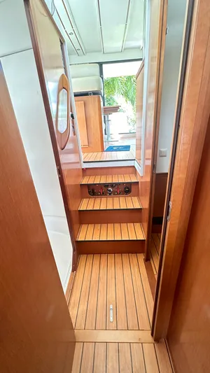  Yacht Photos Pics Interior view of 2009 Beneteau Swift Trawler 34, featuring wooden stairs and flooring.