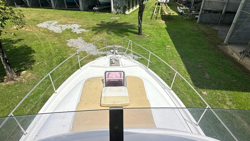  Yacht Photos Pics 2009 Beneteau Swift Trawler 34 on grass, viewed from the deck, surrounded by greenery.
