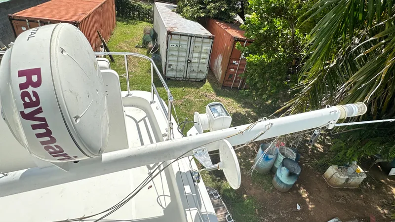  Yacht Photos Pics Beneteau Swift Trawler 34 (2009) with Raymarine equipment, surrounded by shipping containers and greenery.