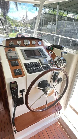  Yacht Photos Pics 2009 Beneteau Swift Trawler 34 helm with wooden steering wheel and navigation controls.
