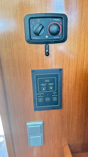  Yacht Photos Pics Control panel on 2009 Beneteau Swift Trawler 34, featuring dials and switches on wooden interior.