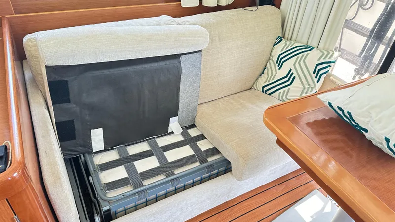  Yacht Photos Pics Interior of 2009 Beneteau Swift Trawler 34 with storage under beige seating.