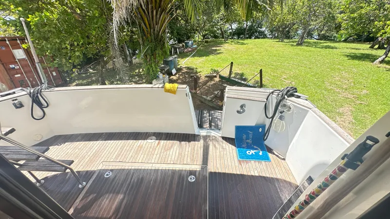  Yacht Photos Pics Beneteau Swift Trawler 34, 2009 model, deck view with lush greenery background.