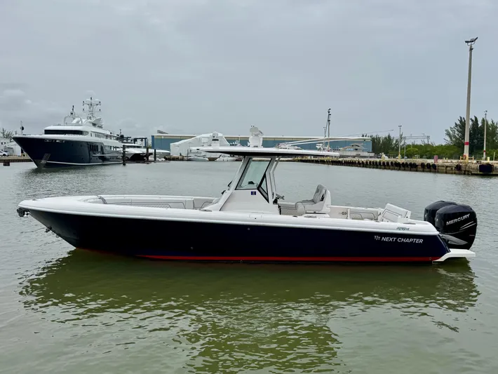  Yacht Photos Pics 2018 Intrepid 327 Center Console boat docked in a marina, side view.