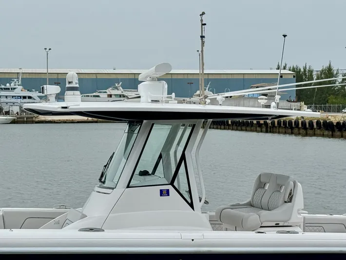  Yacht Photos Pics 2018 Intrepid 327 Center Console boat docked at marina, featuring sleek design and modern equipment.