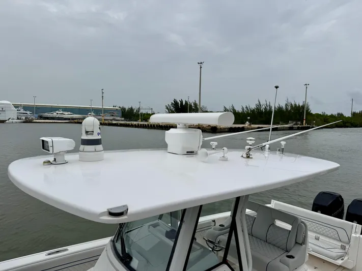  Yacht Photos Pics 2018 Intrepid 327 Center Console boat with advanced navigation equipment on a cloudy day.