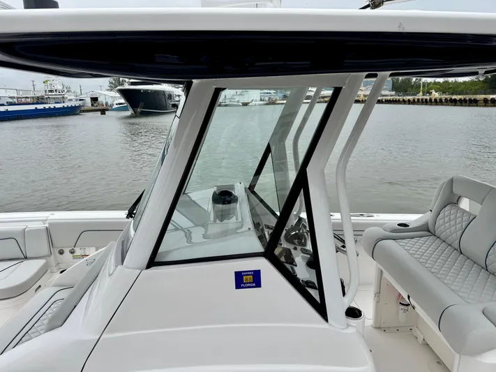  Yacht Photos Pics 2018 Intrepid 327 Center Console boat with sleek design, docked by the waterfront.