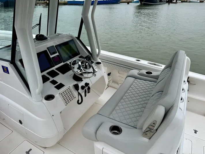  Yacht Photos Pics 2018 Intrepid 327 Center Console boat interior with steering wheel and seating.