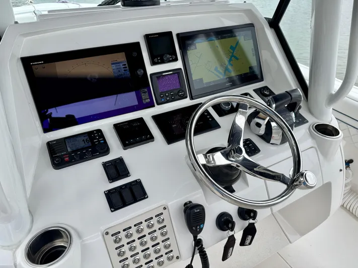  Yacht Photos Pics 2018 Intrepid 327 Center Console dashboard with navigation screens and steering wheel.
