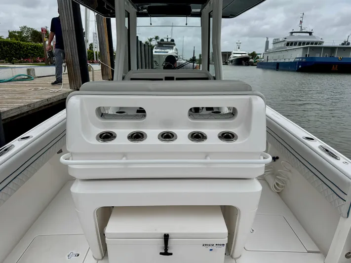  Yacht Photos Pics 2018 Intrepid 327 Center Console boat with seating and rod holders, docked by the water.