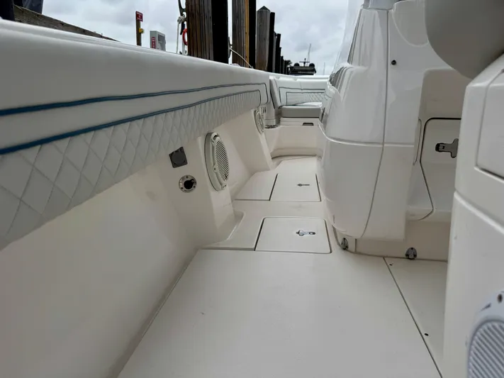  Yacht Photos Pics 2018 Intrepid 327 Center Console boat interior with white seating and storage compartments.