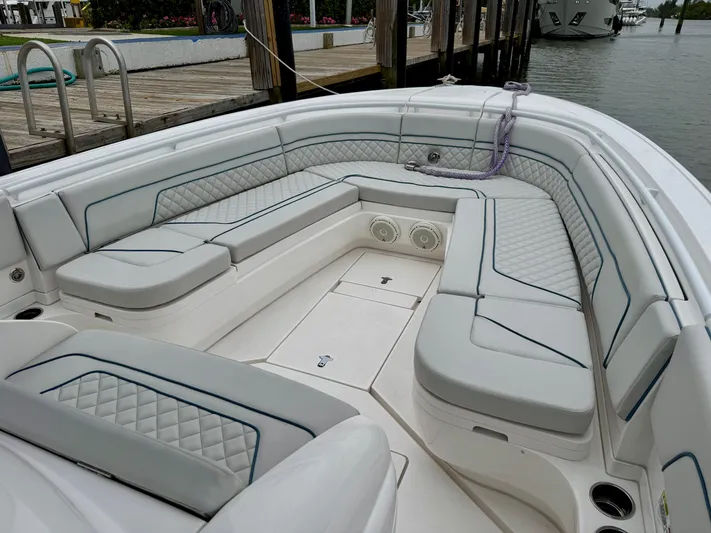  Yacht Photos Pics 2018 Intrepid 327 Center Console boat with spacious seating and elegant design at a dock.