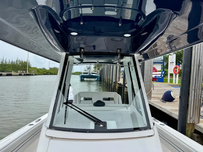  Yacht Photos Pics 2018 Intrepid 327 Center Console boat docked by a marina.