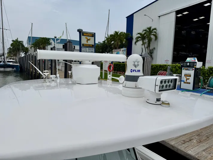  Yacht Photos Pics 2018 Intrepid 327 Center Console with advanced navigation equipment at a marina.