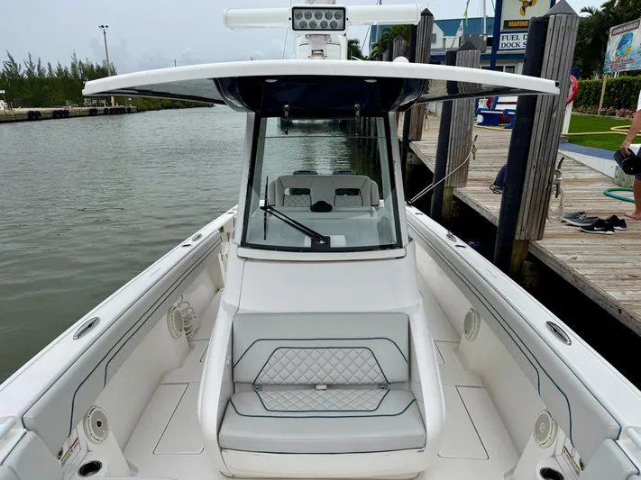  Yacht Photos Pics 2018 Intrepid 327 Center Console boat docked by the water.