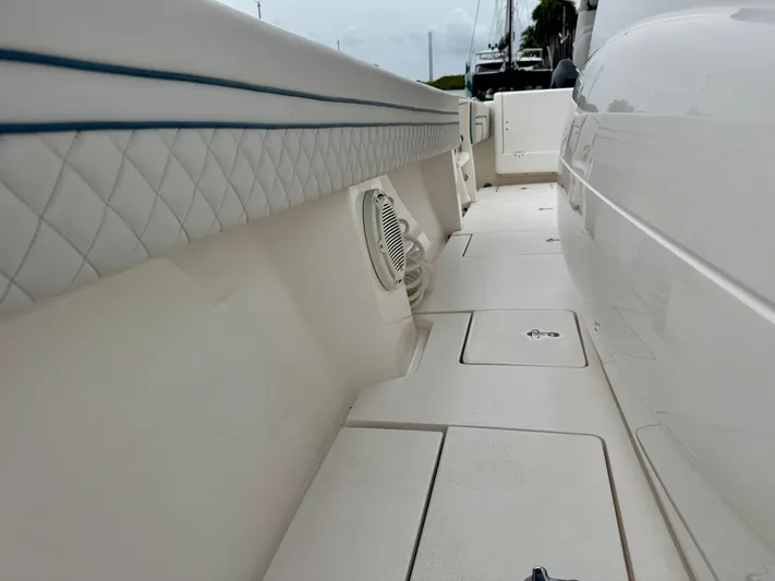 Yacht Photos Pics 2018 Intrepid 327 Center Console boat interior with quilted upholstery and storage compartments.