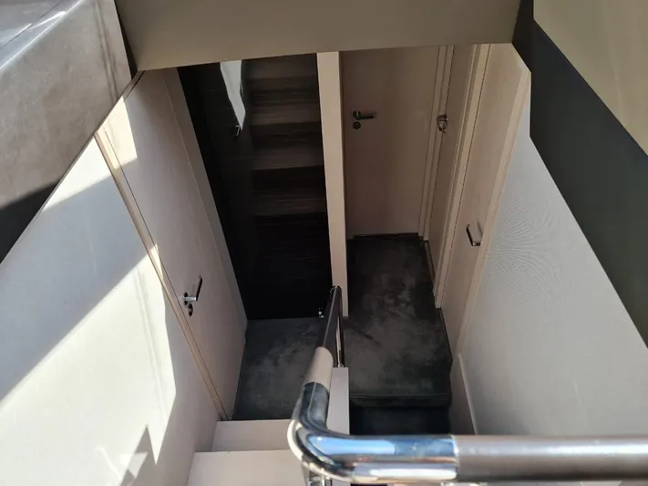 Mi Bluu Yacht Photos Pics Staircase interior of 2019 Azimut Flybridge 66 yacht, featuring sleek design and modern finishes.