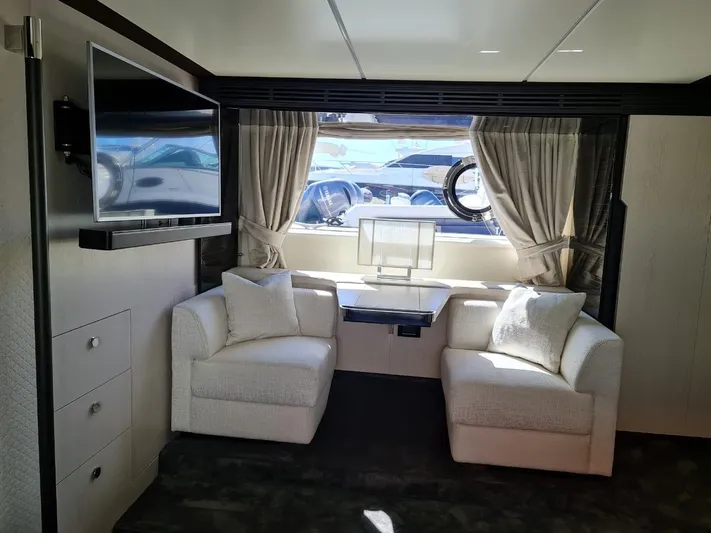 Mi Bluu Yacht Photos Pics Luxurious interior of 2019 Azimut Flybridge 66 yacht with elegant seating and large window.