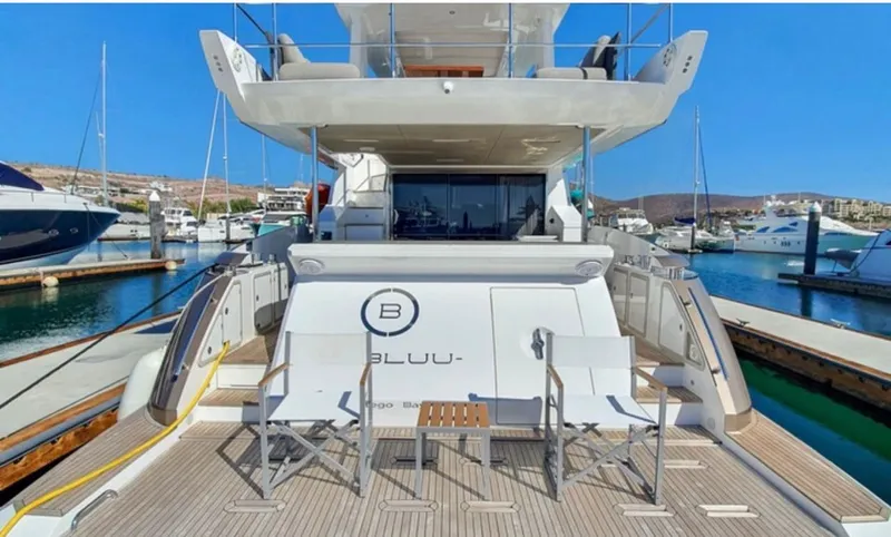 Mi Bluu Yacht Photos Pics 2019 Azimut Flybridge 66 yacht docked, featuring spacious deck and seating area.