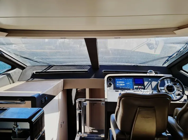 Mi Bluu Yacht Photos Pics Interior view of 2019 Azimut Flybridge 66 yacht cockpit with modern navigation equipment.