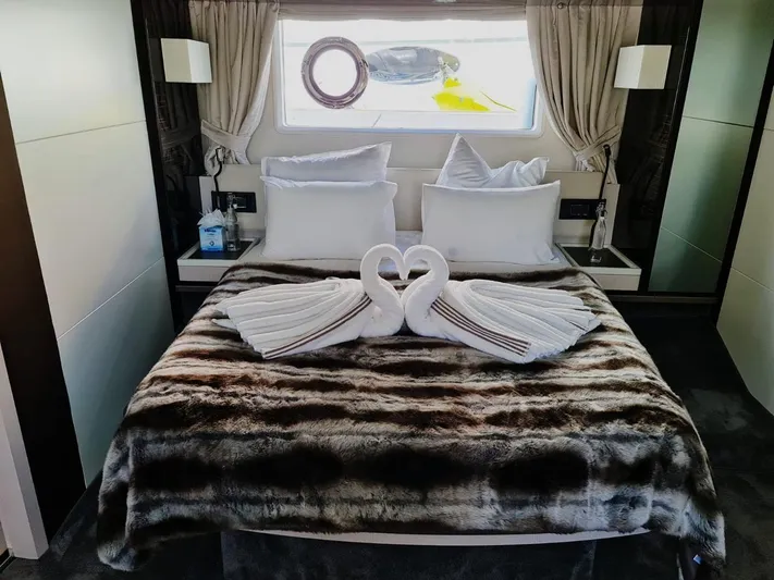 Mi Bluu Yacht Photos Pics Luxurious bedroom on 2019 Azimut Flybridge 66 yacht with elegant swan towel decor.