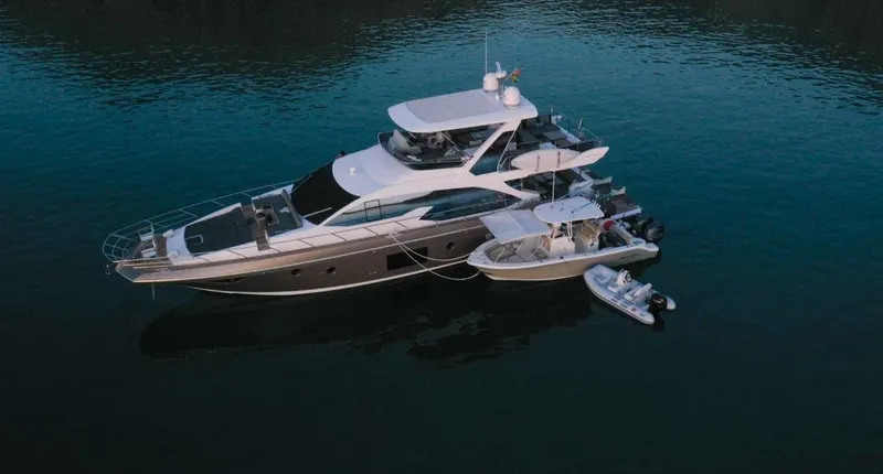 Mi Bluu Yacht Photos Pics 2019 Azimut Flybridge 66 yacht on calm water with small boats attached.