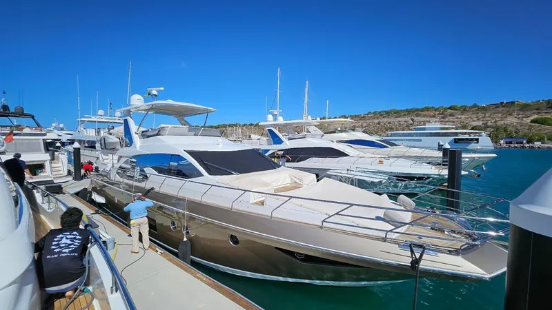 Mi Bluu Yacht Photos Pics 2019 Azimut Flybridge 66 yacht docked in a marina under clear blue skies.