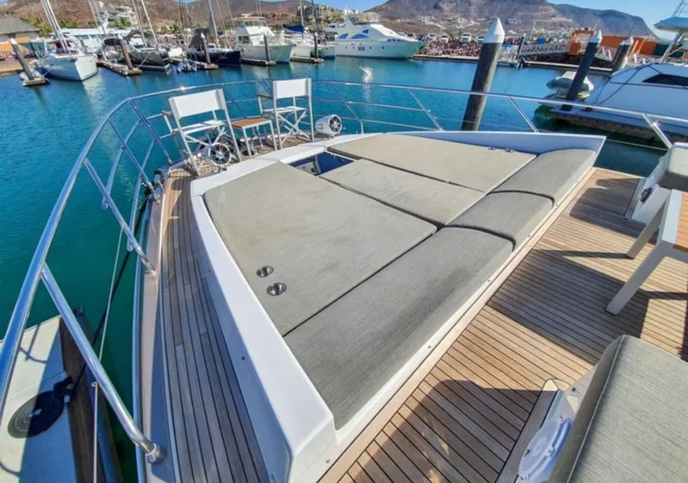 Mi Bluu Yacht Photos Pics 2019 Azimut Flybridge 66 yacht with sunbathing area, docked in a marina.