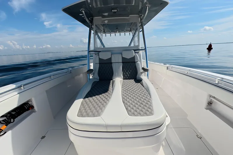  Yacht Photos Pics 2023 Invincible 33 Catamaran interior with luxurious seating on calm waters.