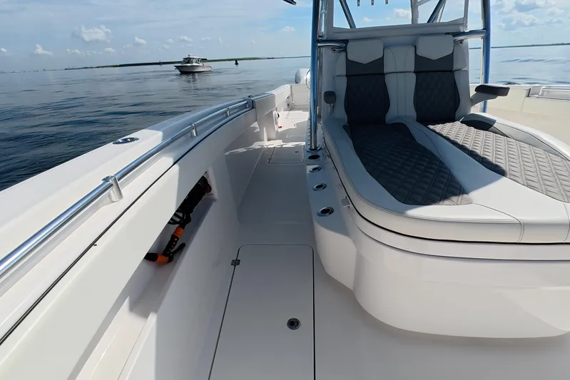  Yacht Photos Pics 2023 Invincible 33 Catamaran with sleek seating and open deck on calm waters.
