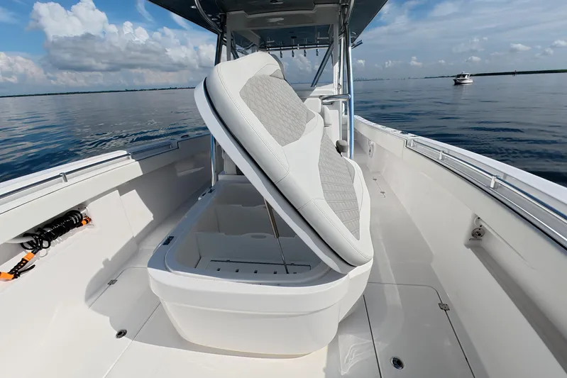  Yacht Photos Pics 2023 Invincible 33 Catamaran interior with open storage compartment on calm water.