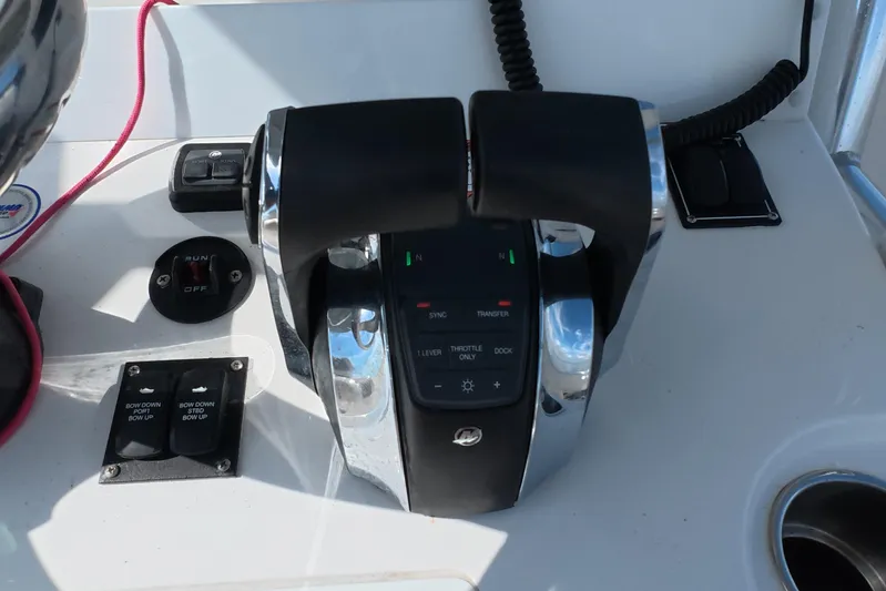  Yacht Photos Pics Throttle controls on 2023 Invincible 33 Catamaran dashboard, featuring modern navigation equipment.