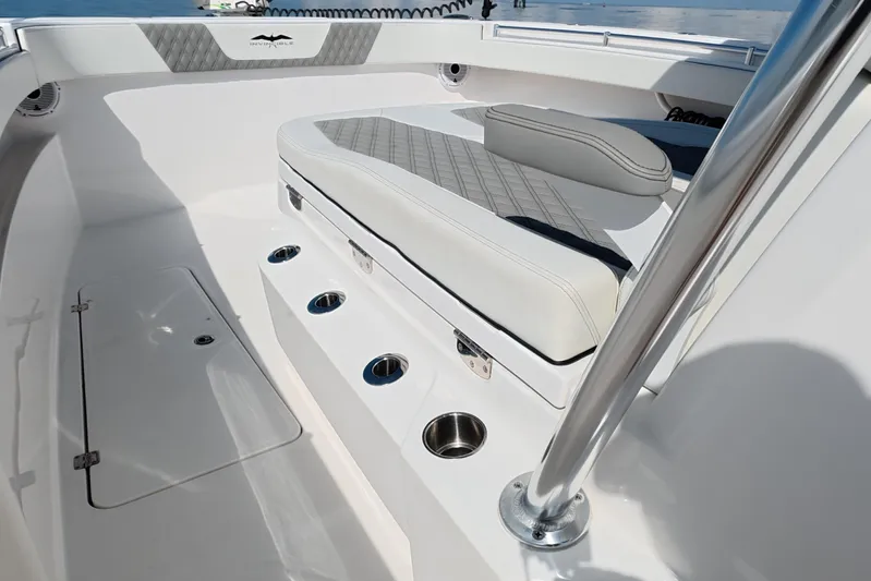  Yacht Photos Pics 2023 Invincible 33 Catamaran interior with cushioned seating and stainless steel cup holders.