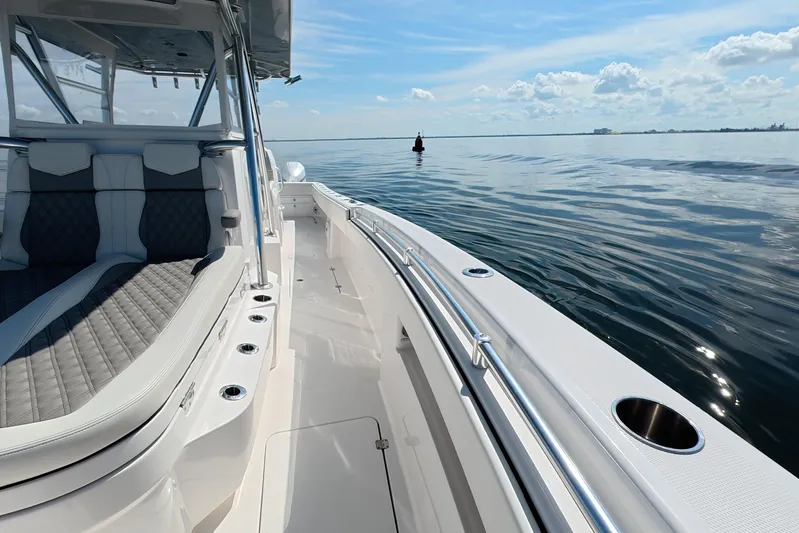  Yacht Photos Pics 2023 Invincible 33 Catamaran on calm waters, showcasing sleek design and luxurious seating.