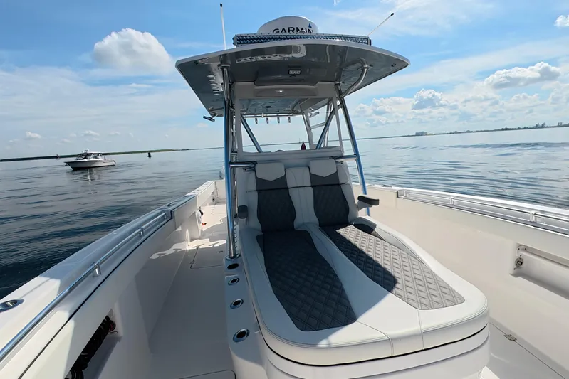  Yacht Photos Pics 2023 Invincible 33 Catamaran on calm waters, featuring sleek seating and modern design.