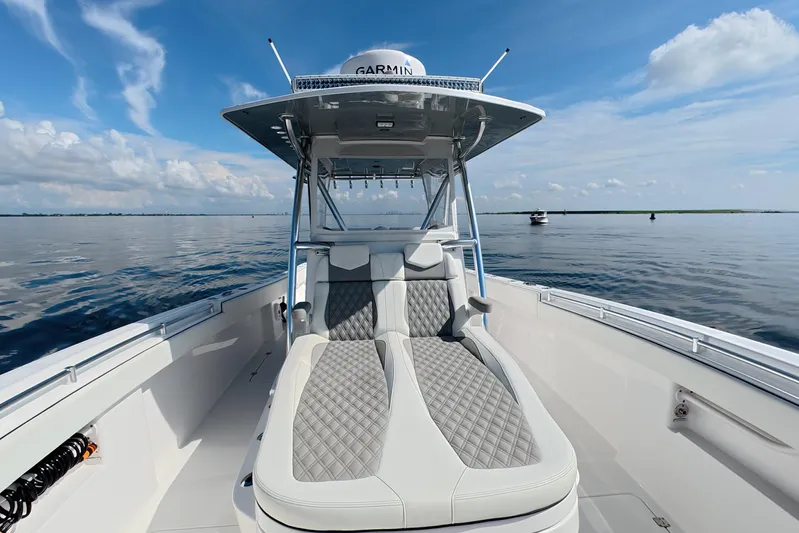  Yacht Photos Pics 2023 Invincible 33 Catamaran on calm water, featuring sleek seating and modern design.