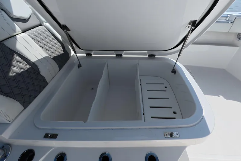  Yacht Photos Pics Open storage compartment on 2023 Invincible 33 Catamaran with cushioned seating.