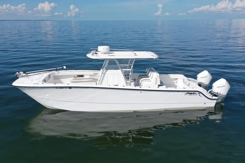  Yacht Photos Pics 2023 Invincible 33 Catamaran on calm ocean waters, showcasing sleek design and twin engines.