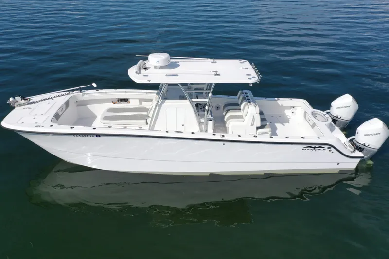  Yacht Photos Pics 2023 Invincible 33 Catamaran on calm water, featuring dual Mercury engines.