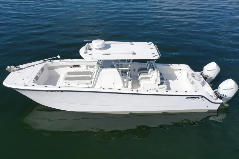  Yacht Photos Pics 2023 Invincible 33 Catamaran on calm water, featuring twin Mercury engines.