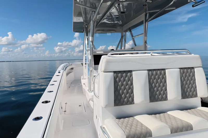  Yacht Photos Pics 2023 Invincible 33 Catamaran on calm water, featuring sleek design and luxurious seating.