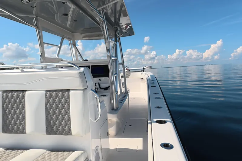  Yacht Photos Pics 2023 Invincible 33 Catamaran on calm water, featuring sleek design and luxurious seating.