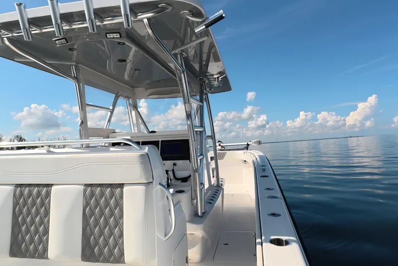  Yacht Photos Pics 2023 Invincible 33 Catamaran on calm water, showcasing sleek design and luxury seating.