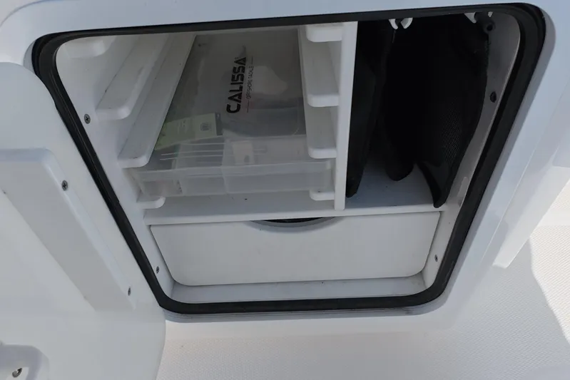  Yacht Photos Pics Storage compartment on 2023 Invincible 33 Catamaran, featuring organized shelves and gear.